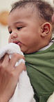 Baby, parent and mouth wipe with cloth for childcare, support or cleaning face in home. Closeup, infant or toddler with fabric, love or care for childhood, meal or youth development together in house