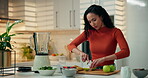 Smoothie, woman and cutting apples in kitchen for breakfast drink, meal replacement or prepare fruit. Blender, person and ingredients in home for organic shake, healthy beverage and digestive health