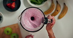 Woman, hands and mixing fruit in blender for healthy smoothie, breakfast drink or meal replacement. Above, person and prepare organic shake in home for nutrition, vitamin benefits or digestive health
