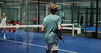 Teenager, playing and learning with coach in padel court for indoor sport training or practice. Children, swing and trainer with balls for exercise game, team match or physical challenge in club