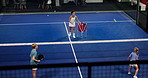 Kids, play padel and ball with coach for technique development, coordination or exercise at club. Woman, boy and girl with sports mentor, above and throw for challenge, racket and teaching on court