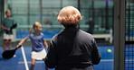 Woman, padel court and watching match with support for indoor sport, game or competition. Back view, female person and spectator with players for tennis challenge, motivation or team practice in club
