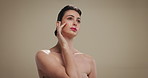Beauty, thinking and touching with woman on studio background for dermatology ideas or vision. Cosmetics, planning and skincare routine with confident model on space for facial results or treatment