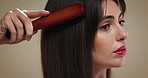 Hair care, beauty and woman with brush in studio for texture, growth or volume. Hairstyle, cosmetics or model with tool for grooming routine, salon or natural oil distribution for shine on background