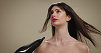 Salon, hair care and hairdryer with woman in studio for beauty treatment, volume and growth. Shine, shampoo and hairdresser tools with person on background for aesthetic, cosmetics and keratin glow