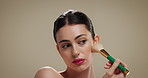 Makeup, brush and woman in studio for beauty, cosmetics products and makeover on brown background. Cosmetology, salon aesthetic and person with tools for foundation, application or glow with red lips