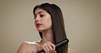 Routine, haircare and woman with iron, heat or equipment for straight hair, texture or getting ready. Studio background, grooming and person with product for hairstyle, straightener or beauty tool