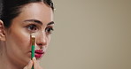 Woman, makeup brush and eyeshadow for beauty, product and mockup space on studio background. Creative, person and model with tools, process and aesthetic for cosmetics for wellness and transformation