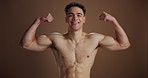 Muscles, flex and face of man in studio for health, fitness and strength on brown background. Bodybuilder, happy and portrait of person with biceps, growth and smile for confidence, pride or wellness