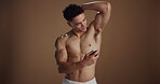 Hygiene, underarm and man with spray, studio background or grooming with product, selfcare or scent. Happy, person and prevention of bad odor, shirtless and fragrance for armpit, smile or skincare