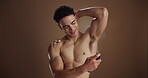 Grooming, underarm and man with spray, studio background and skincare with product, smile and scent. Happy, person and prevention of bad odor, shirtless and fragrance for armpit, self care or hygiene