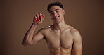 Face, man and happy with grapefruit for skincare for vitamin c, natural detox and studio background. Portrait, male person and topless with fruit, organic ingredients and glow for dermatology results