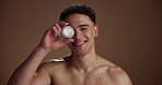 Face, skincare and man with cream container, smile and dermatology on brown studio background. Portrait, space or person with cosmetics, creme and lotion with beauty, aesthetic or grooming with shine