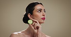 Skincare, natural and woman with cucumber in studio for beauty, glow and facial hydration treatment. Cosmetic, wellness and female person with fruit for face dermatology routine by brown background.