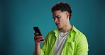 Stress, smartphone and man in studio, online reading and frustrated with email on blue background. Space, bad news and person with cellphone, password error and mistake with digital fraud and scam