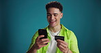 Happy man, phone or banking app with credit card in studio for online shopping on a blue background. Male person, shopper or smile with mobile smartphone or debit for ecommerce or payment on space