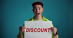 Poster, wow and face of man for discount, bargain and promotion news on blue background. Happy, space and portrait of person with banner for sale announcement, deal and store information in studio
