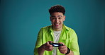 Video games, controller and face of man in studio for online competition, challenge and esports. Space, gamer and portrait of person with console remote for fun, playing and happy on blue background