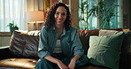 Face, confident and woman in lounge, smile or comfortable on couch in house, happy or relax on break. Resting, person and chilling on sofa in home, calm and pride on weekend, apartment or Canada