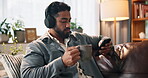 Coffee, streaming and phone with man on sofa for headphones, music playlist or relax. Audio subscription, calm podcast and connection with person in living room of home for album, sound and listening