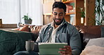 Happy man, tablet and watching with coffee on sofa for online entertainment or streaming in home. Male person, relax and drinking with technology for movie show, series or app subscription in house