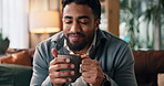 Relax, coffee and man on sofa in home with calm, peaceful and happy morning in living room. Smile, satisfaction and male person drinking cappuccino, latte or warm beverage on couch in apartment.