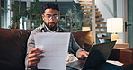 Businessman, finance or documents with laptop on sofa for remote work or report in home. Man, accountant or freelancer with paperwork or computer for financial audit, expenses or budget list in house