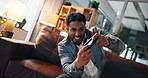 Man, video game and controller on sofa for competition, challenge and esports contest in living room. Person, gamer and click on couch with console, television or online battle for next level at home