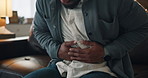 Hands, stomach pain and man on sofa, sick or tummy bug with cramp, indigestion or food poisoning. Person, abdomen and illness with inflammation, constipation and belly ache on couch at apartment