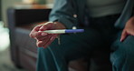 Hands, woman or waiting with pregnancy test in home for IVF treatment, infertility risk or nervous. Anxiety, person and impatient with stick outcome on sofa for pregnant news, expectation and mistake