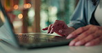 Woman, hands and browsing with laptop in home for research, online connection or network. Closeup, female person or freelancer with computer or technology for software, UI or UX on table in house