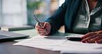 Documents, hand and writing with business person at desk in office for application, audit or tax form. Calculator, paperwork and pen with employee in workplace for accounting, budget or finance