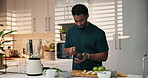 Smoothie, kitchen and man cutting avocado in home for nutrition breakfast, snack or diet. Blender, weight loss and male person with organic fruit for health, wellness or morning drink in house.