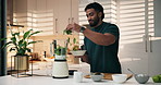 Man, leaves and ingredients with blender in kitchen, happy and meal prep for liquid diet at home. Person, mint and milkshake for wellness, nutrition or detox for gut health benefits at apartment
