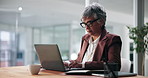 Laptop, notes and businesswoman in office with research for finance budget proposal. Reading, computer and mature female financial manager working on investment report for client in workplace.