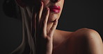 Beauty, hands and lips of woman of black background for cosmetics, dermatology or wellness. Mouth, skincare and touching with model in dark studio for facial results, satisfaction or treatment