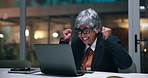 Laptop, night and celebration with business woman for success, financial profit or surprise. Evening, achievement and mature manager with computer for clapping, excited or investment target in office