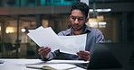 Documents, stress and thinking with business man in office at night for deadline or review. Confused, paperwork and reading with employee at desk in workplace for evening problem solving or search