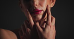 Beauty, hands and mouth of model of black background for cosmetics, dermatology or wellness. Lips, skincare and touching with woman in dark studio for facial results, satisfaction or treatment