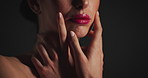 Beauty, hands and mouth of woman of black background for cosmetics, dermatology or wellness. Lips, skincare and touching with model in dark studio for facial results, satisfaction or treatment