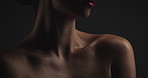 Beauty, skincare and cosmetic with woman in studio on dark background for shadow, art or cosmetology. Aesthetic, dermatology and lighting for serious model in shade for change, transformation or glow