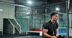 Sports, man and playing padel on court for match practice, game training and workout energy. Night, tennis player and serving ball at health club for technique exercise, fitness performance and skill