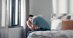 Home, headache and man in bedroom, mental health and pain with anxiety, morning and insomnia. Apartment, tension and person with emotions, sad or burnout with migraine, frustrated or upset with grief