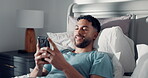 Smile, phone and relax with man in bedroom for social media, text message update and reading. Online news notification, morning and network with person in home for communication app and chat