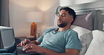 Morning, man and typing on laptop in bed for publication deadline, remote work or upload submission. Freelancer, writer and comfortable with tech in home for editing story, proofreading and research