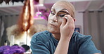 Person, makeup and drag artist in dressing room with application for performance, cabaret or show. Talent, beauty and lgbt performer at club with cosmetics, ready and prepare for concert at theater