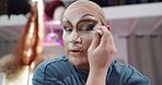 Person, eyeliner and drag artist in dressing room with face for performance, cabaret or show. Talent, beauty and lgbt performer at club with cosmetics, tools and makeup brush for concert at theater