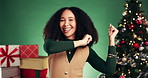 Christmas, dance and face of woman in studio with decorations for tradition, festive or holiday. Happy, music and portrait of female person with rhythm for xmas party or event by green background.