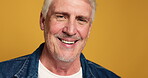 Face, mature man and happy in studio for funny joke, comic story and retirement break. Portrait, male person and smile with laugh, positive attitude and expression with good mood on yellow background