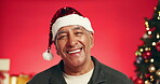 Funny, Christmas and face of old man in studio for holiday season, retirement and smile. Festive celebration, xmas vacation and December break with elderly person on red background for laugh